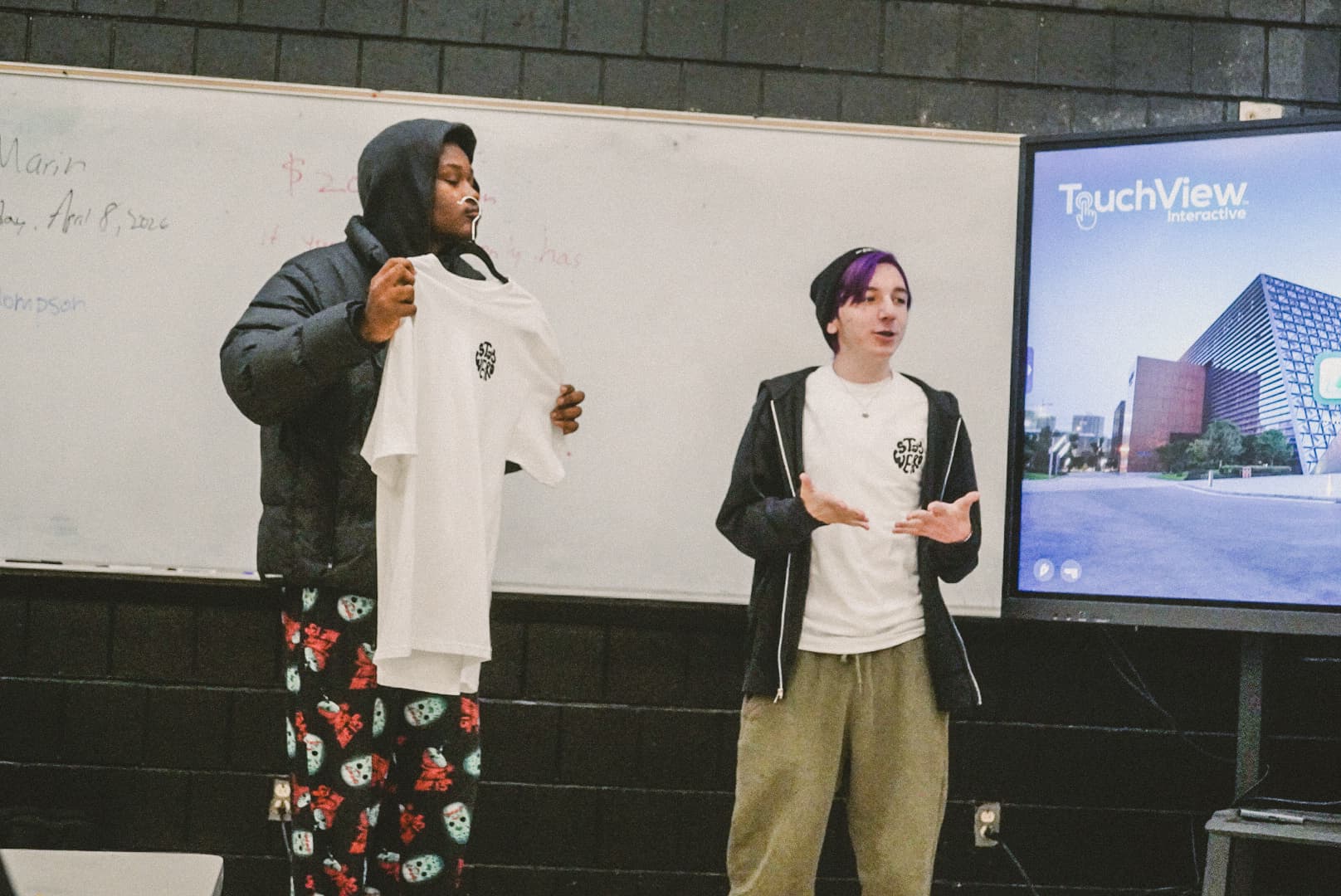 A REBELS student leading a workshop presentation to a seated audience