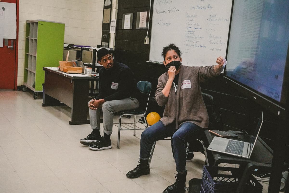 Two REBELS students listening attentively during a cohort session